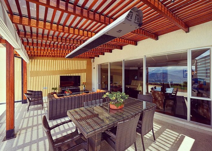 Overhead heater above an outdoor dining table